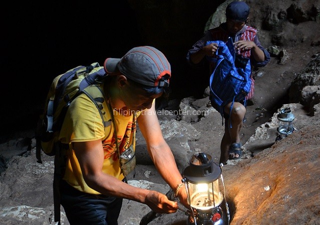 Sagada tour guides preparing their equipments to go into the cave